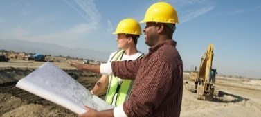 construction workers looking at blueprints